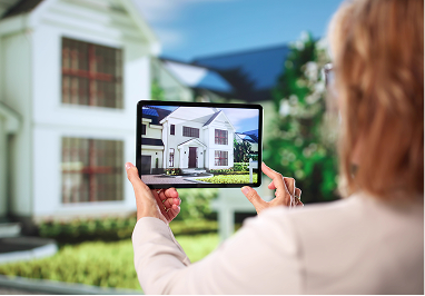Person holding tablet displaying house image.