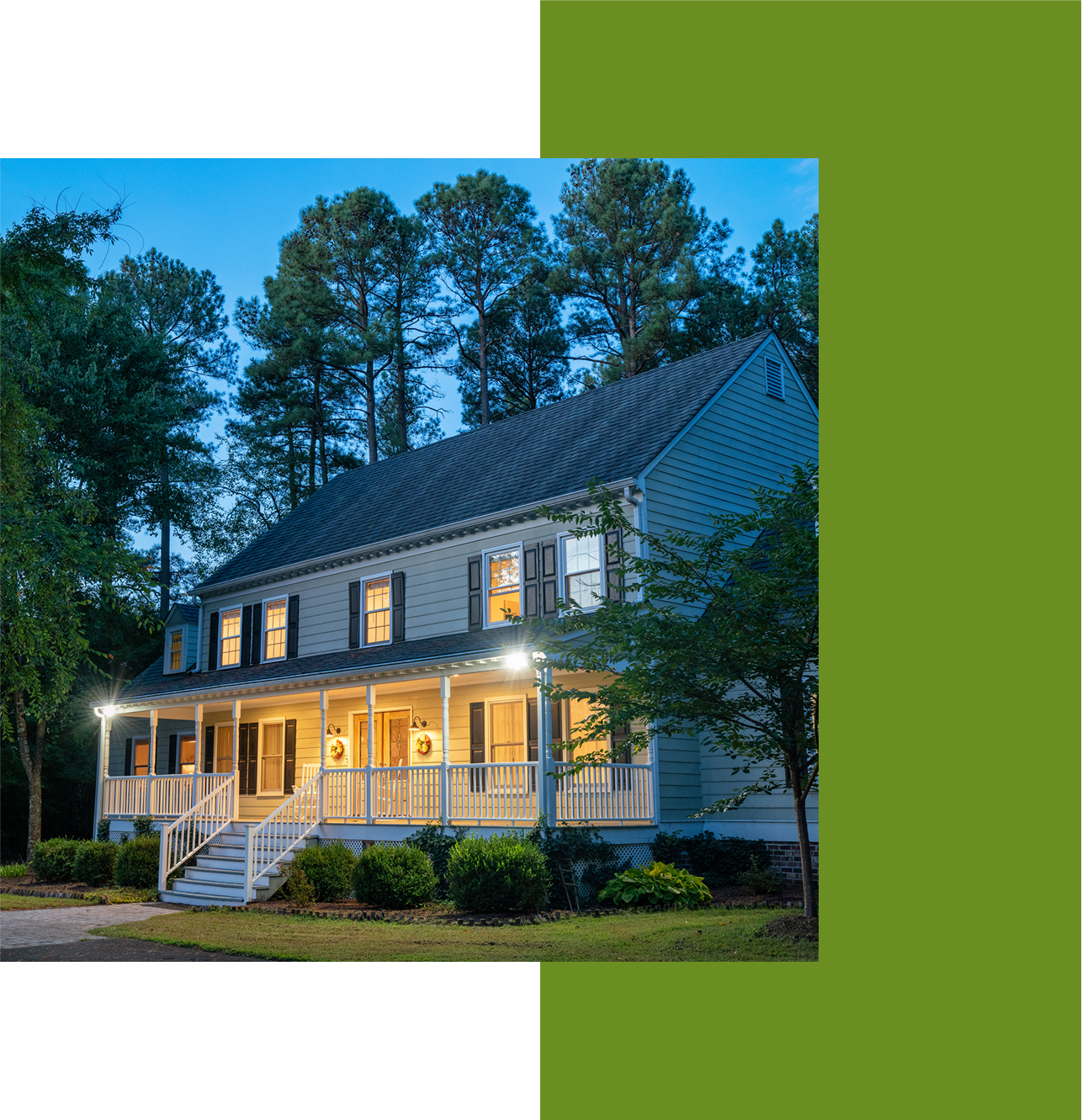 Two-story house with porch at dusk.
